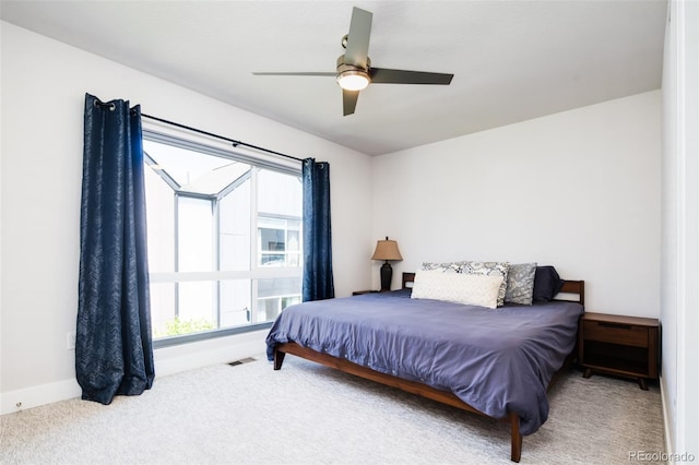 5630 W 11th Pl, Lakewood, CO 80214 - carpeted bedroom featuring multiple windows, baseboards, and a ceiling fan