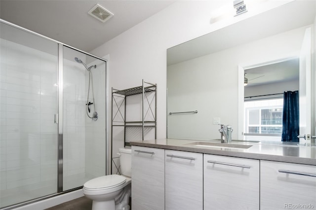 5630 W 11th Pl, Lakewood, CO 80214 - bathroom with toilet, vanity, and a shower stall