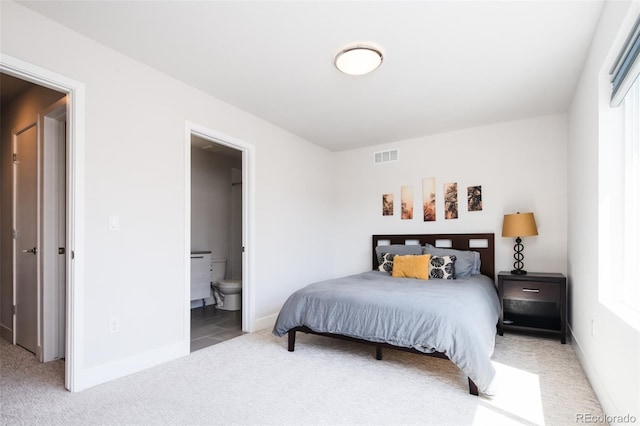 5630 W 11th Pl, Lakewood, CO 80214 - bedroom with light carpet, baseboards, and ensuite bathroom