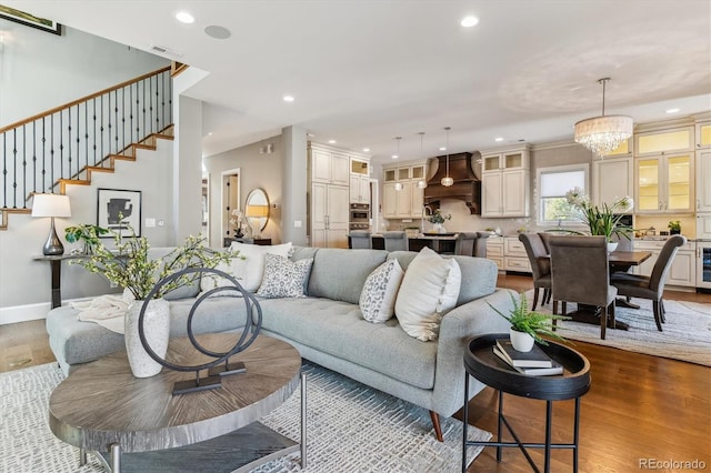 2600 S Adams St, Denver, CO 80210 - living area with wood finished floors, recessed lighting, beverage cooler, stairs, and a chandelier