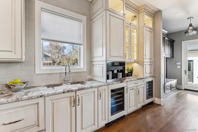 2600 S Adams St, Denver, CO 80210 - bar area with wine cooler, dark wood finished floors, decorative backsplash, and hanging light fixtures