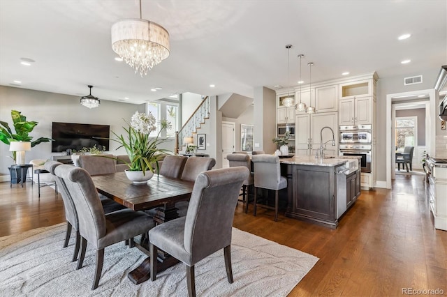 2600 S Adams St, Denver, CO 80210 - dining area with recessed lighting, a chandelier, dark wood-style flooring, and stairs