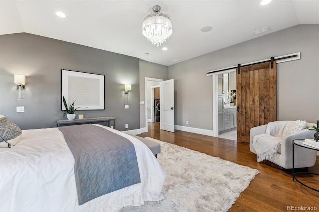 2600 S Adams St, Denver, CO 80210 - bedroom featuring vaulted ceiling, wood finished floors, a barn door, washer / clothes dryer, and recessed lighting