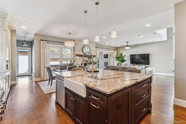2600 S Adams St, Denver, CO 80210 - kitchen featuring dishwasher, dark wood-style flooring, light stone counters, dark brown cabinetry, and open floor plan
