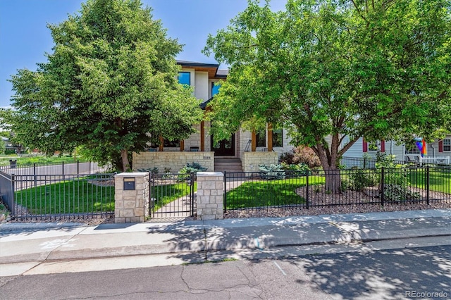2600 S Adams St, Denver, CO 80210 - view of property hidden behind natural elements featuring a fenced front yard and stone siding