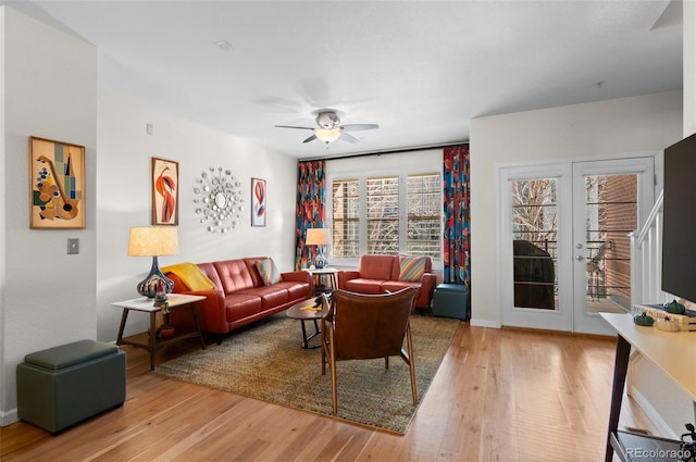 living room featuring french doors, hardwood / wood-style floors, and ceiling fan