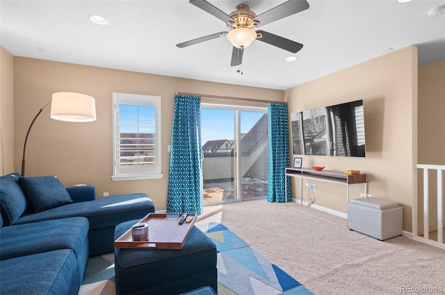 carpeted living room featuring ceiling fan