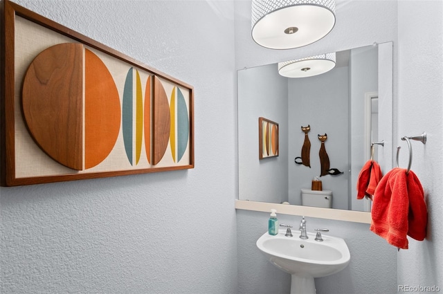 bathroom featuring sink and toilet