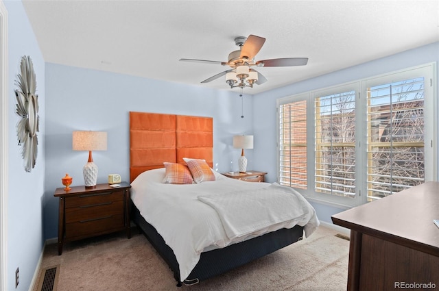 bedroom featuring ceiling fan and light carpet