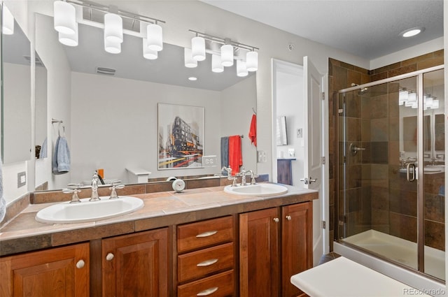 bathroom with vanity and an enclosed shower