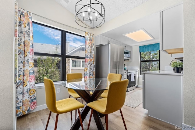 8378 S Upham Way Unit B305, Littleton, CO 80128 - dining room featuring a chandelier and light wood-type flooring