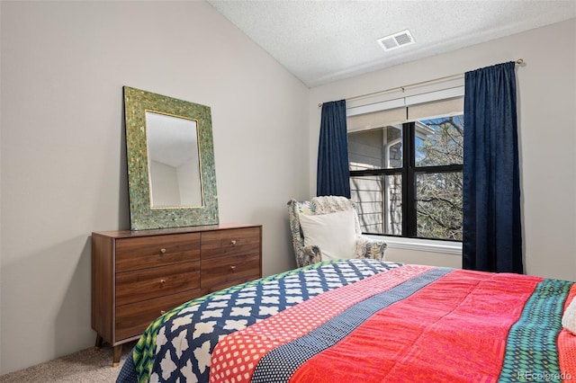 8378 S Upham Way Unit B305, Littleton, CO 80128 - bedroom featuring carpet floors, lofted ceiling, and a textured ceiling