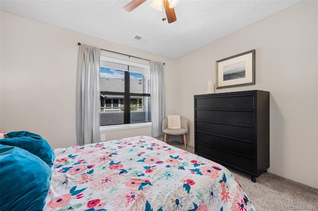 8378 S Upham Way Unit B305, Littleton, CO 80128 - bedroom with light colored carpet, ceiling fan, and a textured ceiling