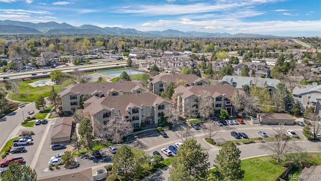 8378 S Upham Way Unit B305, Littleton, CO 80128 - aerial overview of property's location featuring a mountain backdrop and nearby suburban area