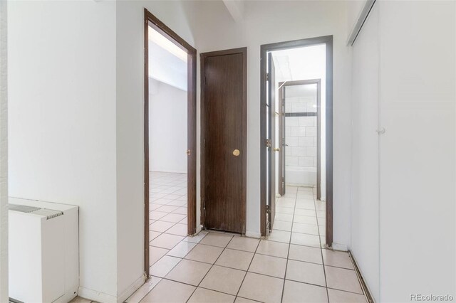 hall featuring light tile patterned floors