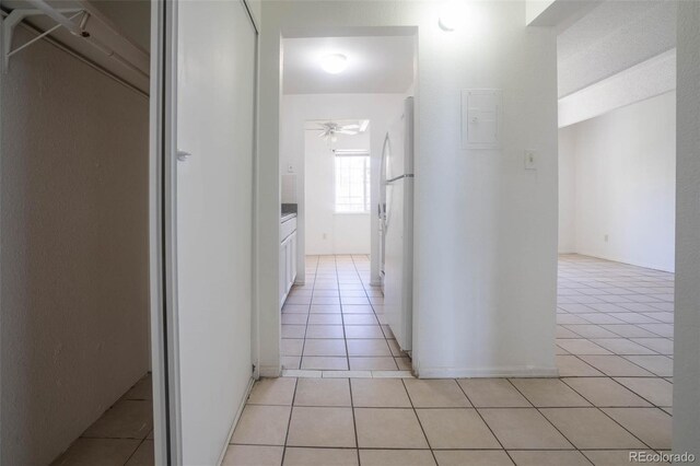 hall featuring light tile patterned floors