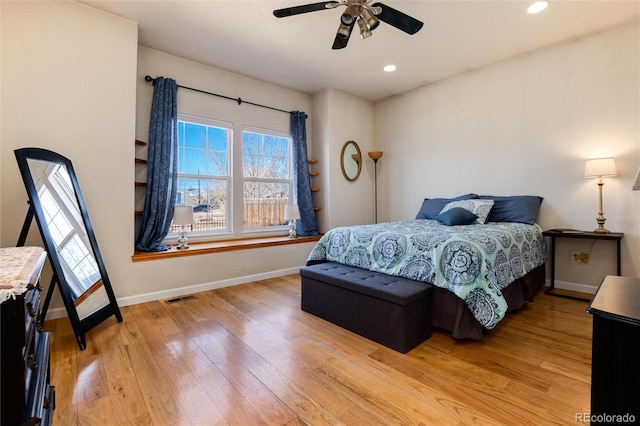 bedroom with ceiling fan and light hardwood / wood-style floors