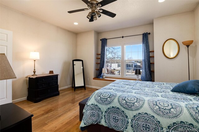 bedroom with ceiling fan and light wood-type flooring