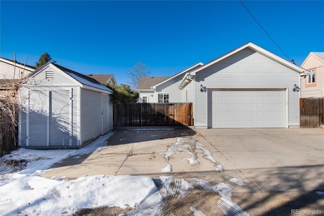 exterior space featuring a garage and a storage shed