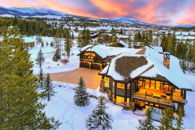 snowy aerial view featuring a mountain view