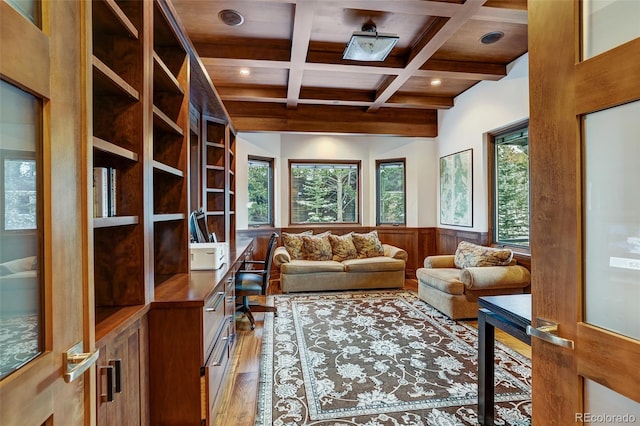 interior space featuring coffered ceiling, a healthy amount of sunlight, light hardwood / wood-style floors, and beamed ceiling