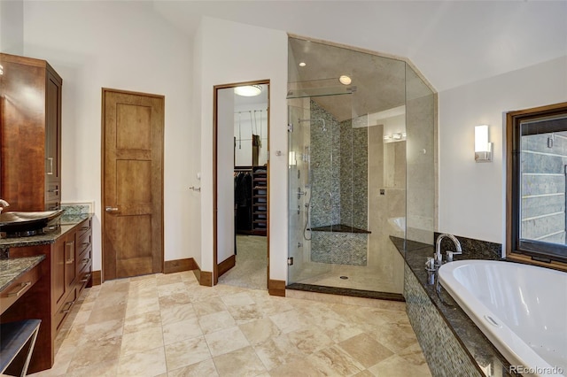 bathroom featuring vanity, plus walk in shower, and vaulted ceiling