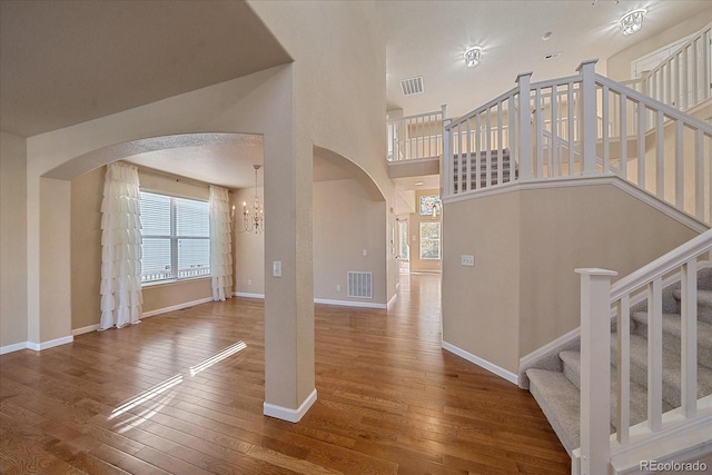 6317 Ruby Hill Dr, Erie, CO 80516 - interior space featuring arched walkways, a wealth of natural light, hardwood / wood-style flooring, and visible vents