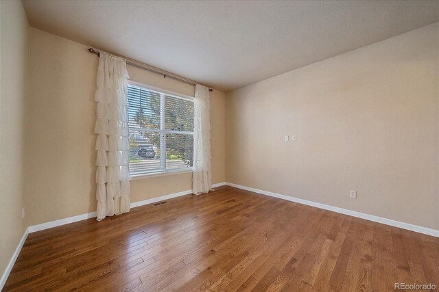 6317 Ruby Hill Dr, Erie, CO 80516 - empty room with baseboards, wood finished floors, and visible vents