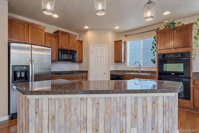 6317 Ruby Hill Dr, Erie, CO 80516 - kitchen with tile countertops, decorative backsplash, a sink, and black appliances
