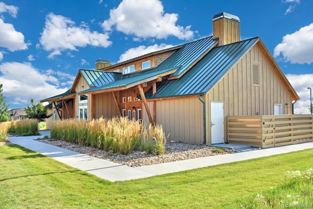 6317 Ruby Hill Dr, Erie, CO 80516 - exterior space featuring a standing seam roof, a chimney, and metal roof