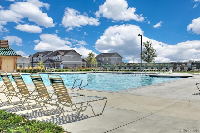 6317 Ruby Hill Dr, Erie, CO 80516 - community pool with fence, a patio, and a residential view
