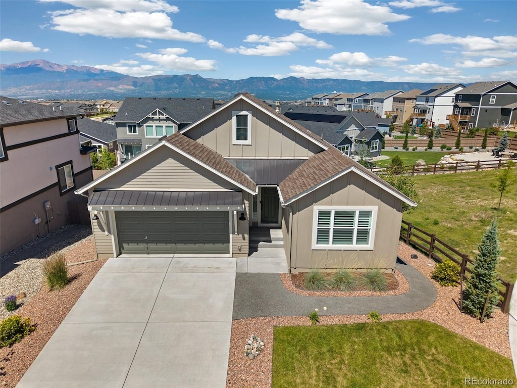 10264 Meadow Mountain Ln, Colorado Springs, CO 80924 - view of front of home featuring a mountain view, board and batten siding, a residential view, driveway, and an attached garage