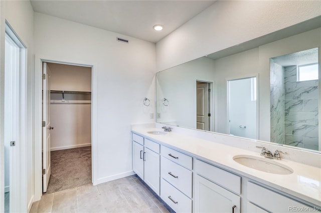 bathroom featuring vanity and tiled shower