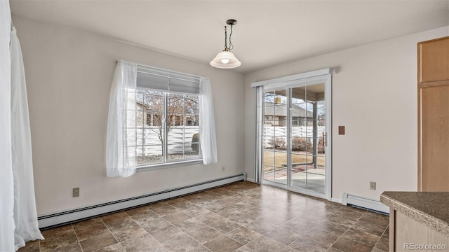 unfurnished dining area with a baseboard heating unit