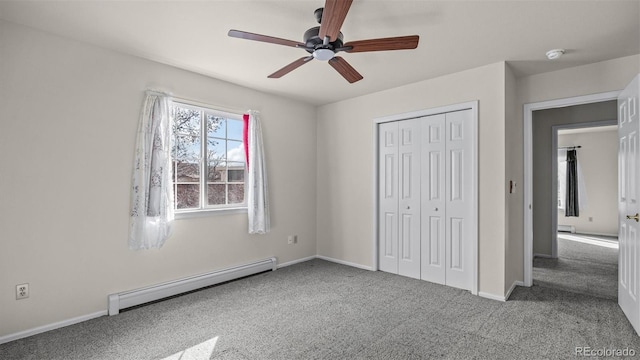 unfurnished bedroom with ceiling fan, a baseboard heating unit, baseboards, a closet, and carpet