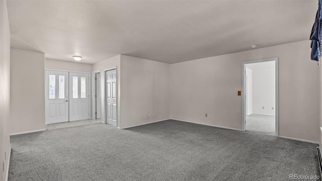 unfurnished room featuring carpet floors and baseboards