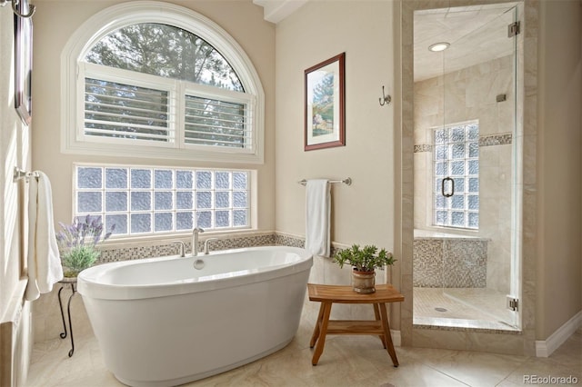 bathroom featuring plus walk in shower and tile patterned flooring