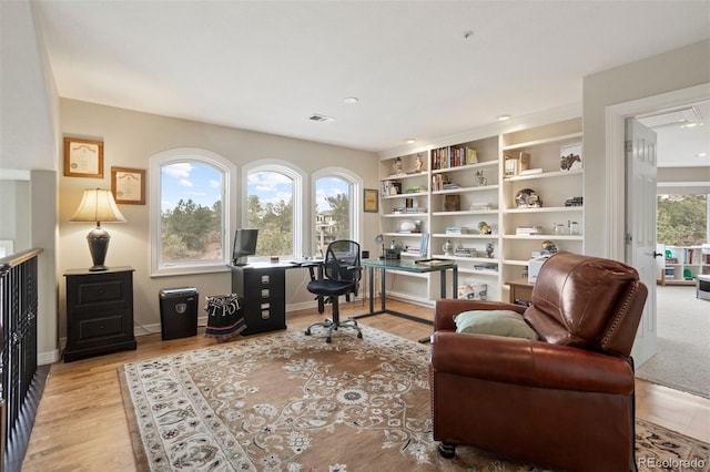 office with light hardwood / wood-style flooring