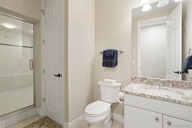 bathroom with vanity, toilet, tile patterned floors, and walk in shower