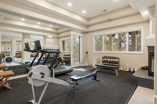 workout area with a raised ceiling