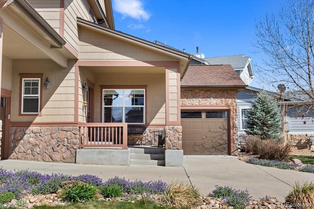 4236 Frederick Cir, Longmont, CO 80503 - property entrance featuring stone siding, driveway, a garage, and a shingled roof