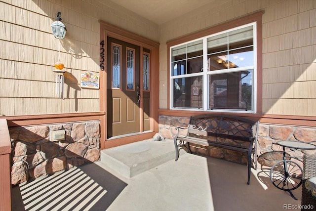 4236 Frederick Cir, Longmont, CO 80503 - view of exterior entry featuring covered porch and stone siding