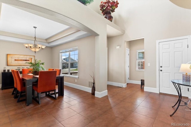 4236 Frederick Cir, Longmont, CO 80503 - tiled dining area featuring a chandelier, baseboards, and arched walkways