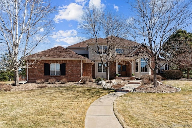 view of front of property featuring brick siding and a front lawn