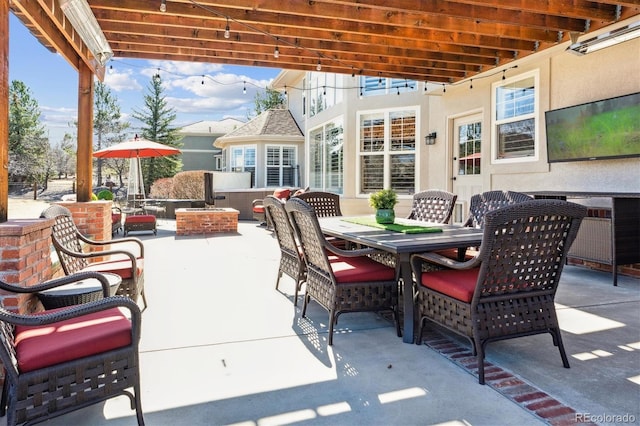 view of patio / terrace with outdoor dining area and an outdoor fire pit