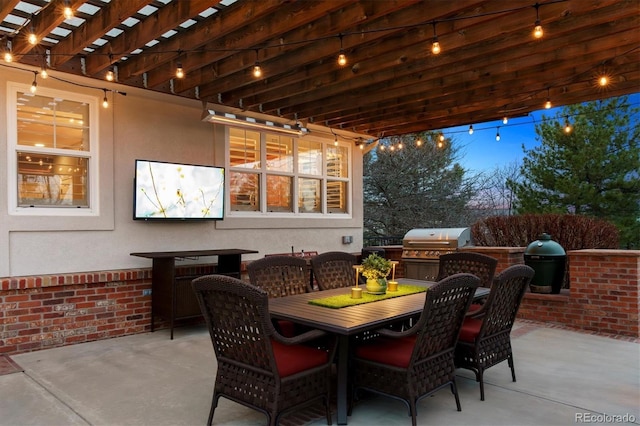 view of patio with area for grilling, an outdoor kitchen, and outdoor dining space