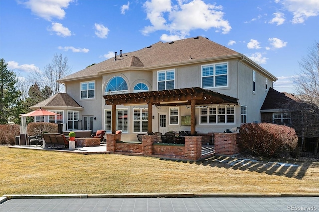 rear view of property with a patio, a yard, a pergola, stucco siding, and outdoor lounge area