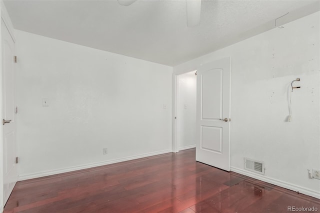 unfurnished room featuring dark wood-type flooring