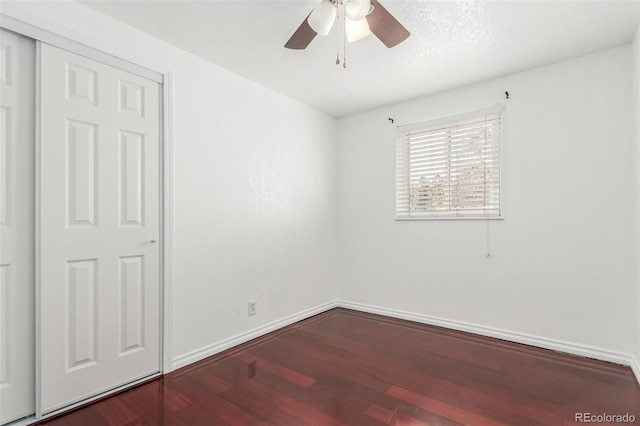 unfurnished bedroom with a closet, ceiling fan, and wood-type flooring