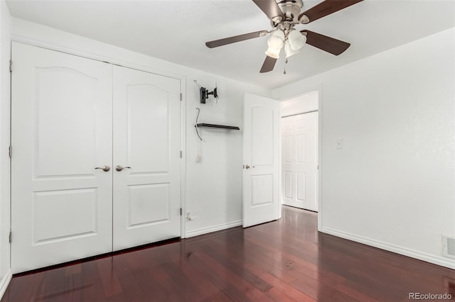 unfurnished bedroom featuring ceiling fan, dark wood-type flooring, and a closet